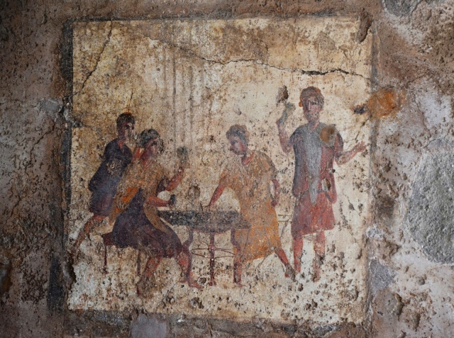 Dice players fresco from the Osteria della Via di Mercurio (VI 10,1.19, room b), in situ wall fresco, Pompeii. Saturnalia